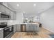 This kitchen has quartz countertops, stainless steel appliances, and a seamless transition into the living room at 7782 93Rd N St, Seminole, FL 33777