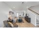 Open concept living room featuring wood-look flooring, a staircase, and seamless transition to the kitchen at 7782 93Rd N St, Seminole, FL 33777