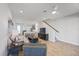 A cozy living room with a ceiling fan, wood-look floors, and seamless access to the kitchen at 7782 93Rd N St, Seminole, FL 33777