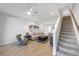 Inviting living area featuring wood-look tile floors and a staircase that ascends to the upper level at 7782 93Rd N St, Seminole, FL 33777