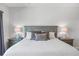 Well-lit main bedroom showcases a large bed with decorative pillows and matching bedside lamps at 7782 93Rd N St, Seminole, FL 33777