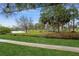 Inviting backyard with manicured lawn, mature shade trees, and relaxing views of community park and lake at 800 71St N Ave # 8, St Petersburg, FL 33702