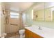 Bathroom featuring tiled shower and floors, modern vanity with hard surface countertop, and updated plumbing fixtures at 800 71St N Ave # 8, St Petersburg, FL 33702