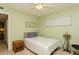 Bedroom features light green walls, ceiling fan, and neutral tile flooring at 800 71St N Ave # 8, St Petersburg, FL 33702
