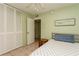 Bedroom features light green walls, ceiling fan, neutral tile flooring, and large closet at 800 71St N Ave # 8, St Petersburg, FL 33702