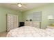 Bright bedroom features a ceiling fan, updated windows, and charming, white furniture with updated lighting at 800 71St N Ave # 8, St Petersburg, FL 33702
