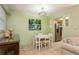 Bright dining area featuring a modern light fixture and adjacent kitchen access at 800 71St N Ave # 8, St Petersburg, FL 33702