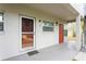 The front door of the home is red and has a glass screen door, along with other front doors at 800 71St N Ave # 8, St Petersburg, FL 33702