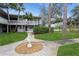 Inviting condo exterior with a lush lawn, mature trees, and a serene outdoor view at 800 71St N Ave # 8, St Petersburg, FL 33702