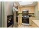 Kitchen featuring stainless steel refrigerator, gas range, and light wood cabinets at 800 71St N Ave # 8, St Petersburg, FL 33702