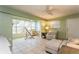 Spacious living room with a sunroom, tile floors, ceiling fan and lots of light at 800 71St N Ave # 8, St Petersburg, FL 33702
