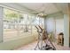 Bright sunroom featuring a ceiling fan, an exercise machine and large windows showcasing outdoor views at 800 71St N Ave # 8, St Petersburg, FL 33702