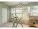 Bright sunroom featuring a ceiling fan, an exercise machine and large windows showcasing outdoor views at 800 71St N Ave # 8, St Petersburg, FL 33702