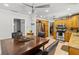 Dining area showcases a large wooden table with chairs near the kitchen and stainless steel refrigerator at 8555 140Th St, Seminole, FL 33776