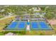 Aerial view of tennis courts in a well-maintained community with mature trees at 860 Glen More Ct # B, Palm Harbor, FL 34684