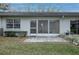 Charming backyard with a screened porch and a paved patio at 860 Glen More Ct # B, Palm Harbor, FL 34684