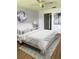 Staged bedroom featuring a comfortable bed, stylish decor, and ample natural light at 860 Glen More Ct # B, Palm Harbor, FL 34684