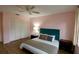 Bedroom featuring wood-look floors, a plush bed, and a closet with white folding doors at 860 Glen More Ct # B, Palm Harbor, FL 34684