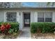 Charming front entrance with a well-maintained garden, front door and stone exterior at 860 Glen More Ct # B, Palm Harbor, FL 34684