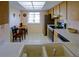 Bright eat-in kitchen features stainless steel appliances and a window for natural light at 860 Glen More Ct # B, Palm Harbor, FL 34684