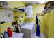 Laundry room featuring a washer, dryer, storage racks, and yellow painted walls at 860 Glen More Ct # B, Palm Harbor, FL 34684