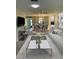 Bright living room featuring stylish decor, modern furniture, and attached dining room with built-in shelves at 860 Glen More Ct # B, Palm Harbor, FL 34684