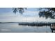 Waterfront view of the lake featuring a community boat dock with boat slips and calm waters at 90 S Highland Ave # 224, Tarpon Springs, FL 34689
