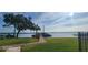 Picturesque waterfront featuring a private dock, lush green lawn, and a serene lake view, perfect for boating and relaxation at 90 S Highland Ave # 224, Tarpon Springs, FL 34689