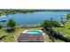 Aerial view showcasing a pool overlooking a picturesque lake and lush greenery, providing a serene atmosphere at 903 Setter Ct, Seffner, FL 33584