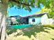 Spacious backyard featuring a large tree with swings, a screened-in porch, and well-maintained landscaping at 903 Setter Ct, Seffner, FL 33584