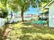 Landscaped backyard with mature tree, play equipment, and privacy fence at 903 Setter Ct, Seffner, FL 33584