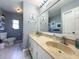 Well-lit bathroom with double vanity, a large mirror, and neutral tones at 903 Setter Ct, Seffner, FL 33584