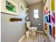 Cozy bathroom featuring a toilet, patterned shower curtain, and decorative wall art at 903 Setter Ct, Seffner, FL 33584