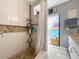Shower with pebble flooring, tile walls and a colorful painted glass door to the outside at 903 Setter Ct, Seffner, FL 33584