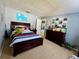 Spacious bedroom with a large bed, dresser, and a fun dinosaur theme, perfect for  at 903 Setter Ct, Seffner, FL 33584