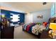 Stylishly designed bedroom with bright blue accent wall, a cozy bed, and ample natural light at 903 Setter Ct, Seffner, FL 33584