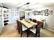 Dining room boasts stylish lighting, neutral walls, and a view into living space at 903 Setter Ct, Seffner, FL 33584