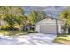 Beautiful home featuring a stone-accented facade, lush landscaping, and a spacious driveway at 903 Setter Ct, Seffner, FL 33584