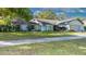 Charming single Gathering home with lovely lawn, attached garage, and beautiful landscaping at 903 Setter Ct, Seffner, FL 33584