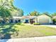 Charming single Gathering home with lovely lawn, attached garage, and beautiful landscaping at 903 Setter Ct, Seffner, FL 33584