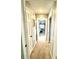 Hallway leading to a bedroom featuring carpet flooring, white trim, and fresh paint at 903 Setter Ct, Seffner, FL 33584