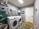 Functional laundry room with modern washer and dryer, shelving, and ample storage space at 903 Setter Ct, Seffner, FL 33584