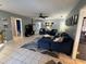 Inviting living room with ample seating, a large TV, tiled floors, and a ceiling fan for added comfort at 903 Setter Ct, Seffner, FL 33584