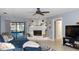Cozy living room featuring a fireplace with a clock, tile flooring, sliding glass doors leading to pool, and comfortable seating at 903 Setter Ct, Seffner, FL 33584