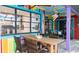 Patio dining area featuring colorful accents, ceiling fan, and view into interior spaces at 903 Setter Ct, Seffner, FL 33584
