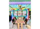 Patio dining area with colorful accent walls, ceiling fan, and view into the kitchen at 903 Setter Ct, Seffner, FL 33584