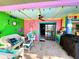 Relaxing patio with colorful decor, comfortable seating, ceiling fan and access to interior at 903 Setter Ct, Seffner, FL 33584