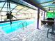 Screened pool with patio and outdoor dining area features vibrant colors and accents at 903 Setter Ct, Seffner, FL 33584