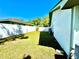 Side yard featuring a well-maintained lawn, privacy fence, and the side of the house at 903 Setter Ct, Seffner, FL 33584