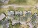 An aerial view of a residential neighborhood with well-maintained homes, lush landscaping, and paved roads at 1015 Harefield Cir, Sun City Center, FL 33573